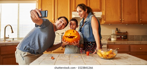 Family Taking Selfie With Jack-o-lantern For Halloween