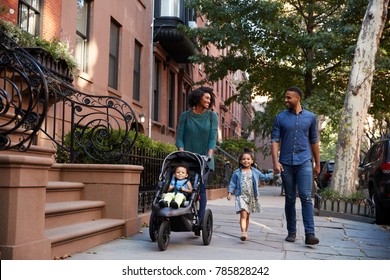 Family taking a walk down the street