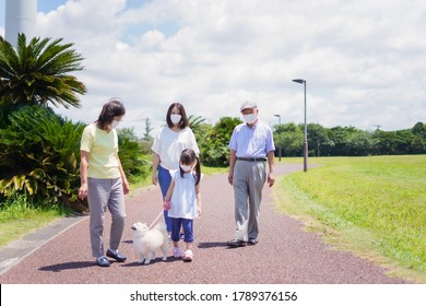 Family Taking A Walk With Face Mask