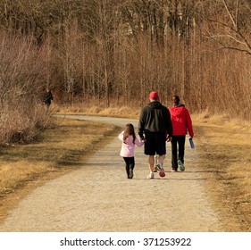 Family Taking A Walk On A Warm Winter Day; Midwest