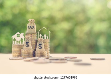 Family tax benefit / residential property or estate tax concept : Tax burlap bag, family members, house on rows of coin money, depicts mandatory financial charge / type of levy imposed upon a taxpayer - Shutterstock ID 1297631998