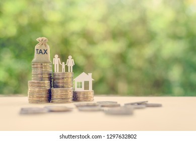Family tax benefit / residential property or estate tax concept : Tax burlap bag, family members, house on rows of coin money, depicts mandatory financial charge / type of levy imposed upon a taxpayer
