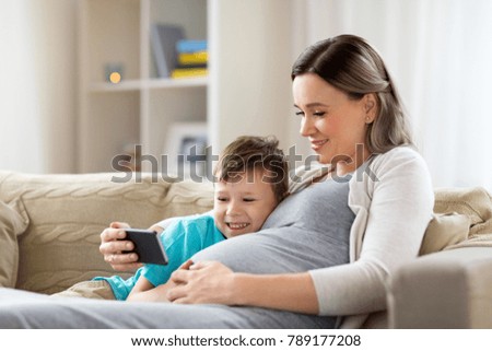 Similar – Image, Stock Photo Pregnant woman and little daughter in the rustic kitchen