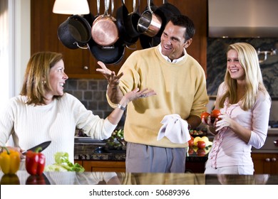 Family With Teen Girl Talking Together In Kitchen