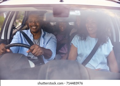 Family With Teenage Children In Car On Road Trip