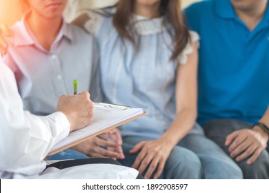 Family Therapist , Parent With Troubled Teenager Mental Health Concept. Father, Mother And Problem Depressed Teen Daughter With Psychologist Or Social Worker Counselor In Therapy Session.