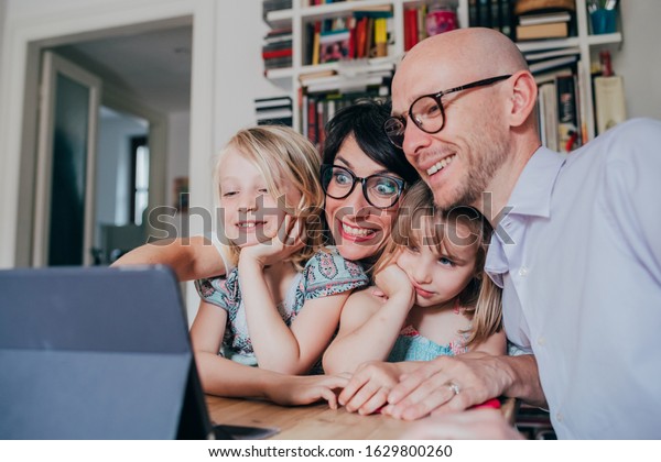 family with three children indoor\
using tablet - togetherness, technology, entertainment\
concept