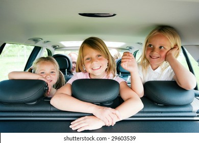 Family With Three Kids In A Car