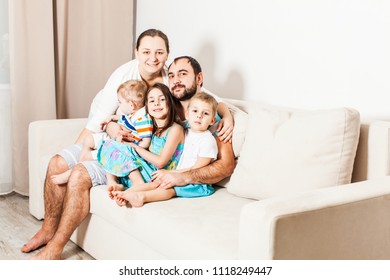 Family with three kids posing for a family photo. - Shutterstock ID 1118249447