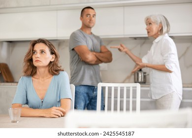 Family of three - mother-in-law, daughter and son quarreling in kitchen - Powered by Shutterstock