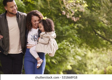 Family Of Three On A Walk, Mother Holding Child, Close Up