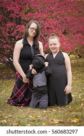 Family Of Three Outside With Fall Colors Being Silly