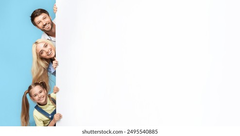 A family of three smiles brightly as they peek from behind a large white wall. The father stands at the top, followed by the mother, and their young daughter. - Powered by Shutterstock