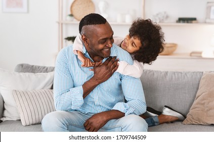 Family time at home. Lovely little girl hugging her grandfather, expressing her love indoors. Panorama - Shutterstock ID 1709744509