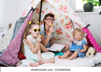 Family time: Mom and some of the sisters' children play at home in a children's homemade tent. - Powered by Shutterstock