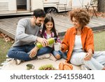 Family time together. Road trip. family with kid having picnic outdoors on the porch of camper van trailer motor home. Adventures, away from everything