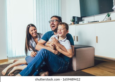 Family time.Mother,father and son having fun at home.