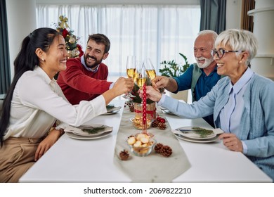 Family Toasting At Christmas Dinner In The Dinning Room