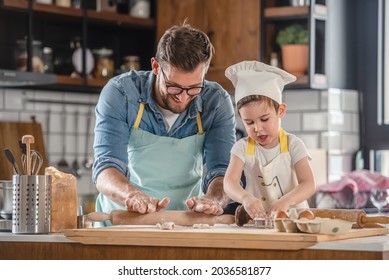 Family together in the kitchen. Father making cake with his toddler son. - Powered by Shutterstock