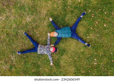 family top view. lying on the grass. sunny day. in green nature together. Aerial view Drone photography - Powered by Shutterstock