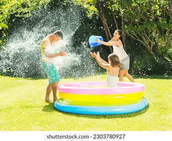 Family tossing water on father in backyard - Powered by Shutterstock - Get 15% off with code: PIKWIZARD15