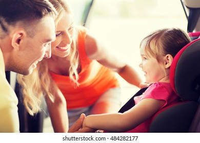 Family, Transport, Safety, Road Trip And People Concept - Happy Parents Talking To Little Girl In Baby Car Seat