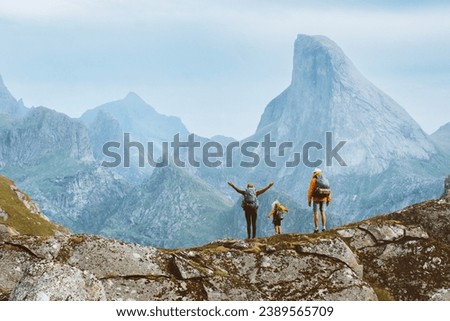 Family travel adventure in Norway mountains, parents and child on active outdoor vacation. Mother, father, and kid hiking together healthy lifestyle tour in Lofoten islands, freedom concept