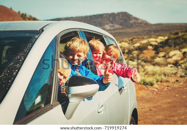 family travel by car- happy mother with tree\
kids in mountains