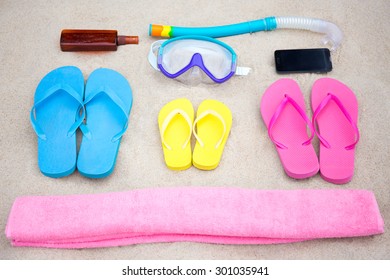 Family Travel Concept - Close Up Of Summer Beach Accessories On The Sand