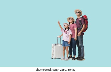 Family Travel Concept, Full body Happy asian family vacation, Father, mother and little daughter carrying  suitcases with hand pointing ready for vacation trip, isolated on pastel plain light blue - Shutterstock ID 2250780481