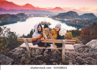 Family Travel Europe. Bled Lake At Autumn Or Winter Time, Slovenia, Europe. Top View On Island With Catholic Church In Bled Lake With Castle And Mountains In Background.