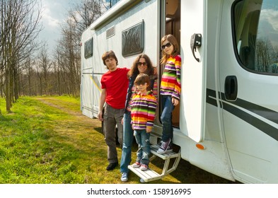 Family Travel In Motorhome (RV) On Vacation, Happy Parents And Kids Having Fun Near Camper 