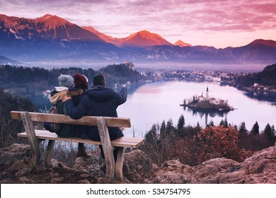 Family Travel Slovenia, Europe. Bled Lake One Of Most Amazing Tourist Attractions. Winter Landscape. Top View On Island With Catholic Church In Bled Lake With Castle And Alps Mountains In Background.