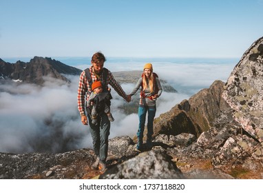 Family Travel Vacations Man And Woman Hiking With Baby Carrier Outdoor In Mountains Healthy Lifestyle Mother And Father Walking Holding Hands Summer Trip In Norway