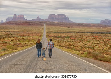 Family Travel And Walking Down Road To Monument Valley While Holding Hands With A Child