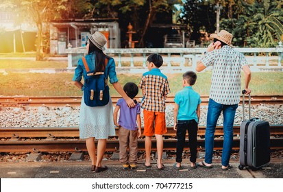 Family Traveler  Looking For Train Coming On Vacation.man Woman And Children Waiting For The Train Come On Vacation.transportation Concept.