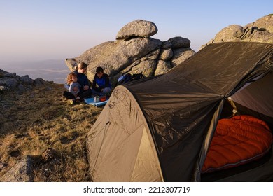 Family Of Travelers Having Breakfast Outside Tent