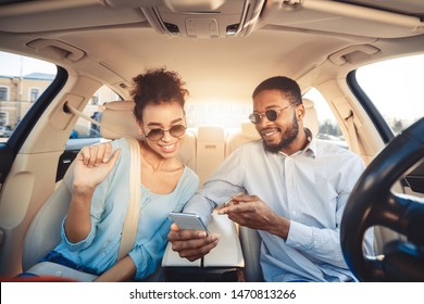 Family Traveling By Car. African-american Couple Using Navigator App On Phone