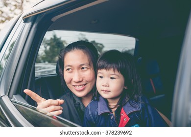 Family Traveling By Car. Asian Mother And Little Lovely Daughter Travel On Vacation. Happy Parent And Kid Have Fun. Outdoors.