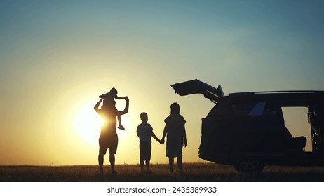 family traveling by car. family watching sunset silhouette next to the car in the park. happy family kid dream concept. people in the park. family car camping resting lifestyle in nature - Powered by Shutterstock