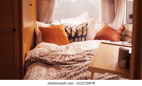Family traveling in camper.Inside house on wheels,trailer,motor home.Bed in little bedroom.Romantic road travel,freedom life.Campsite overnight,van parking.Wanderlust vacation,weekend.Happy adventure.