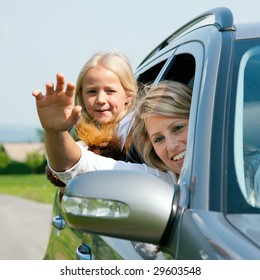 Family Travelling By Car, Mother Waving With Hands