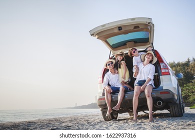 Family trip, summer vacation travel. Happy family sitting in car trunk. Father, mother and son were on their way to the sea or river or ocean.