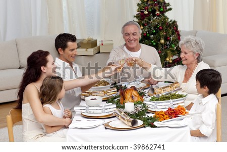 Family tusting in a Christmas dinner at home