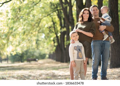 Family With Two Children In Autumn Park