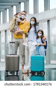 Family with two children going on holiday, wearing face masks at the airport. - Shutterstock ID 1781340176