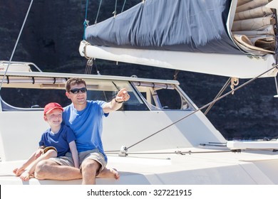 Family Of Two Enjoying Summer Vacation At Catamaran Boat At Kauai Island, Hawaii