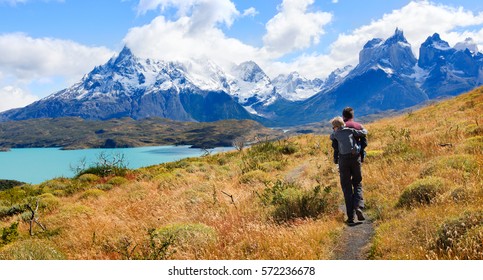 Family Of Two, Father And Son, Enjoying Hiking And Active Travel In Torres Del Paine National Park In Patagonia, Chile, View Of Cuernos Del Paine And Pehoe Lake