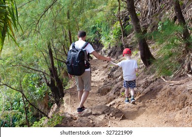 Family Of Two Hiking Together The Kalalau Trail At Kauai Island, Hawaii