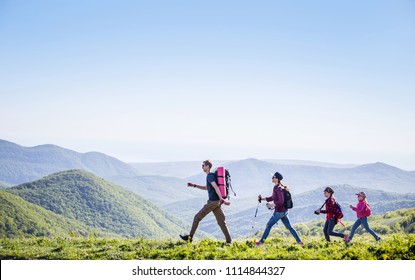  Family With Two Kids Have Hiking  Through The Mountains